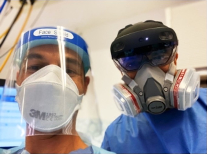 Two clinicians in full PPE with a HoloLens 2 headset during a Covid-19 consultation at Great Western Hospitals